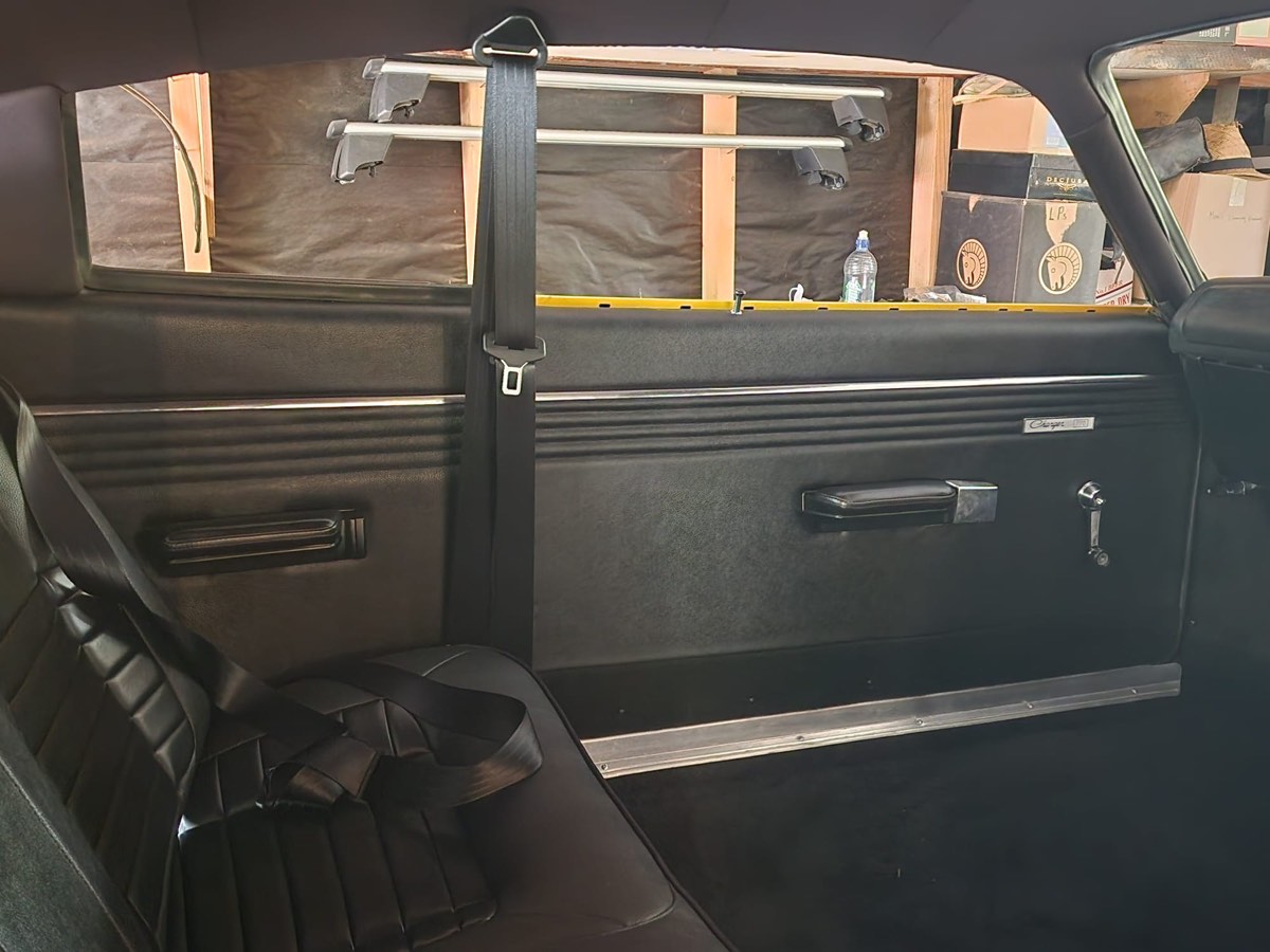 Chrysler Charger after — full black interior restoration with new door cards, headliner and seat belts