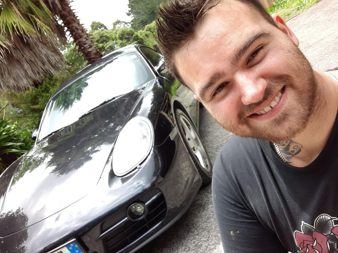 Jay, owner of Jay's Auto Trim, with a Porsche outside the Massey workshop